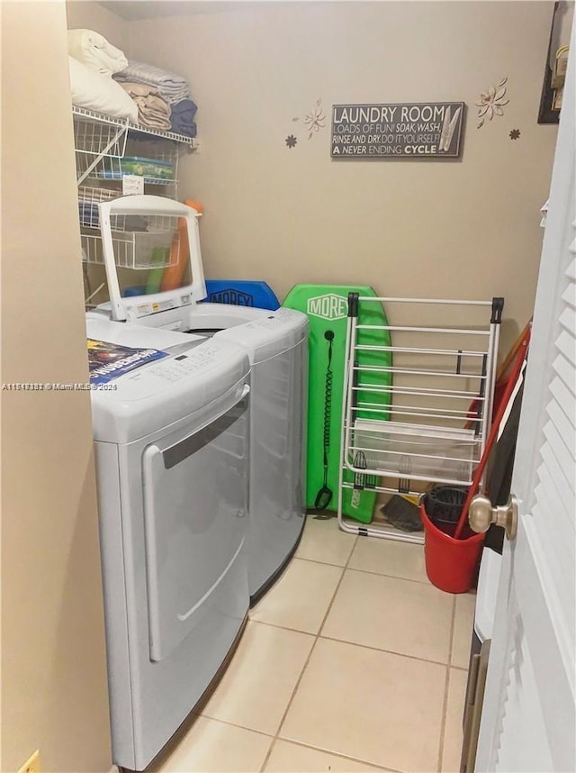 clothes washing area featuring tile patterned floors and independent washer and dryer