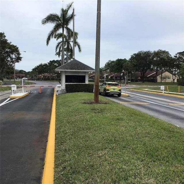 1013 Green Pine Blvd Unit C2, West Palm Beach, FL 33409 - view of asphalt road featuring street lights and curbs