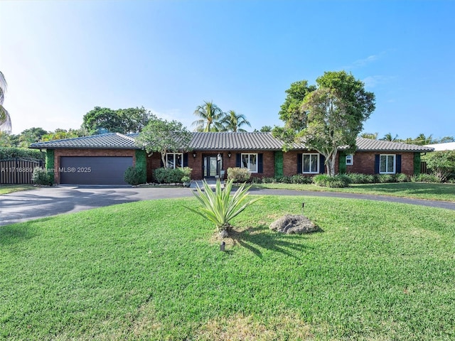 single story home with a front lawn and a garage