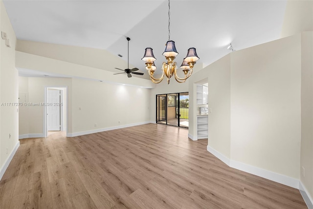 interior space with ceiling fan with notable chandelier, lofted ceiling, and light hardwood / wood-style flooring