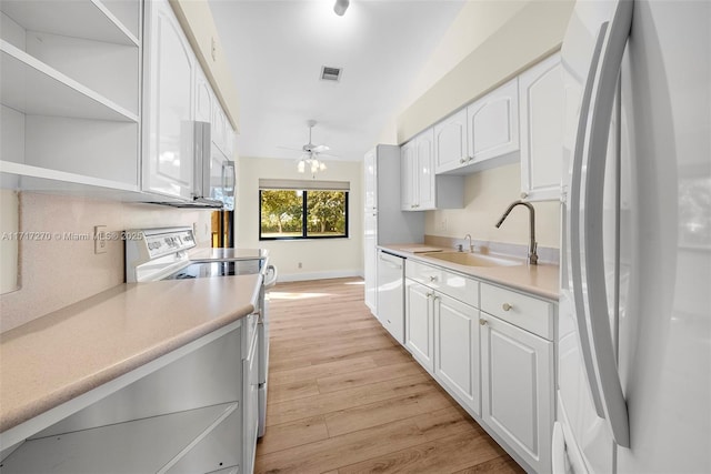 kitchen featuring white appliances, ceiling fan, sink, light hardwood / wood-style flooring, and white cabinetry