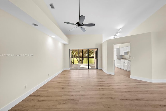 unfurnished living room featuring ceiling fan, light wood-type flooring, and track lighting