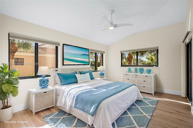 bedroom featuring multiple windows, light hardwood / wood-style floors, and ceiling fan