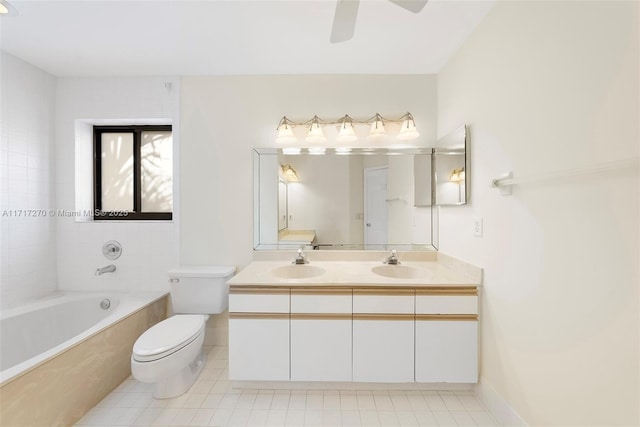 full bathroom with tiled shower / bath, tile patterned flooring, vanity, and toilet