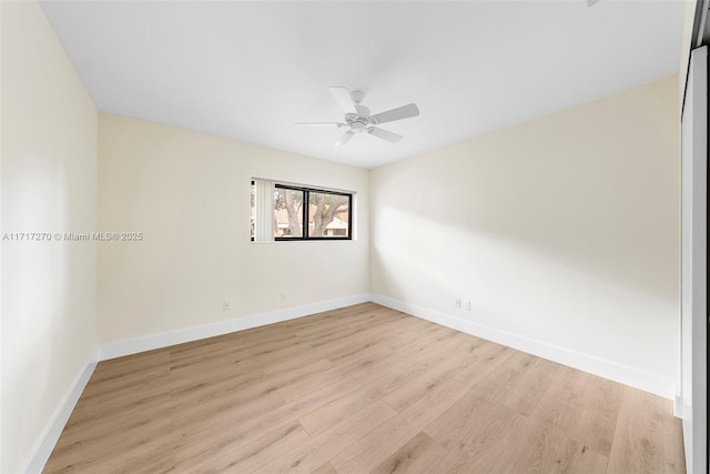 empty room with ceiling fan and light hardwood / wood-style floors