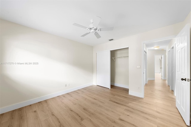 unfurnished bedroom with ceiling fan, a closet, and light wood-type flooring