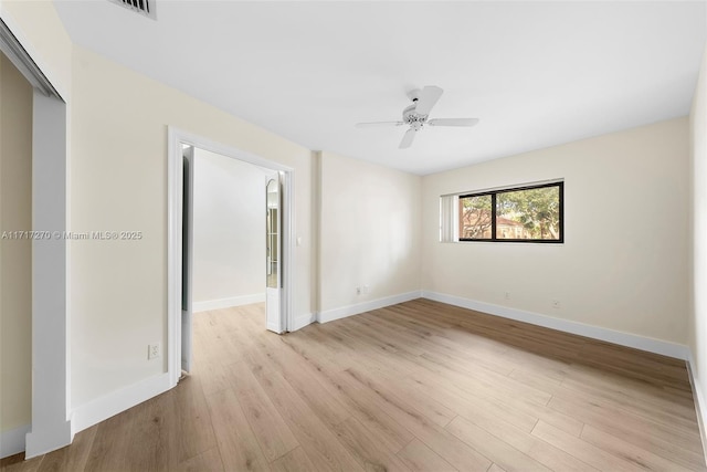 spare room with ceiling fan and light wood-type flooring