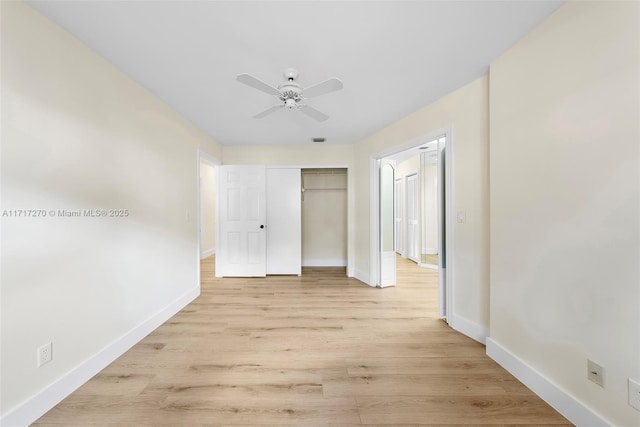 unfurnished bedroom with ceiling fan, light hardwood / wood-style floors, and a closet