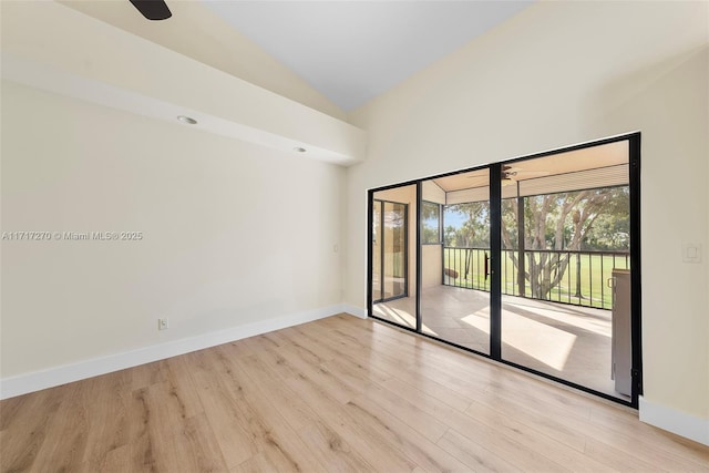 spare room featuring light hardwood / wood-style flooring and vaulted ceiling