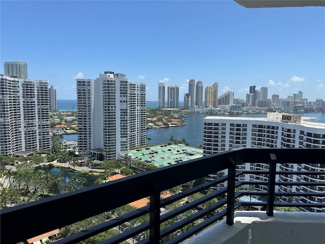 balcony with a water view and a city view