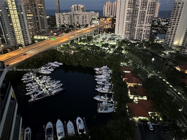 drone / aerial view featuring a water view and a view of city