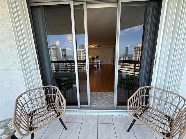 property entrance with a view of city and a balcony