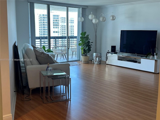 living room with wood finished floors and floor to ceiling windows