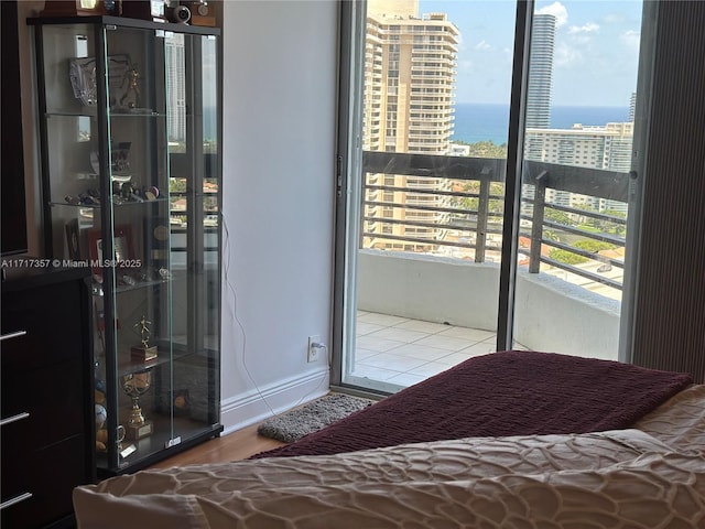 unfurnished bedroom featuring a water view and a city view