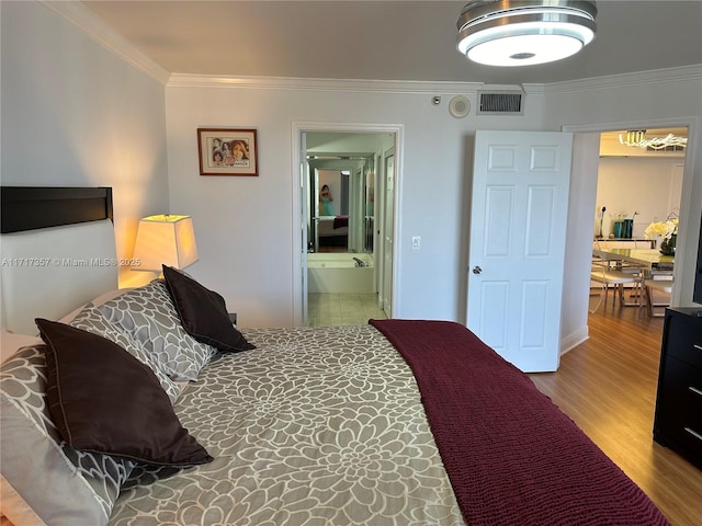 bedroom with ornamental molding, wood finished floors, and visible vents