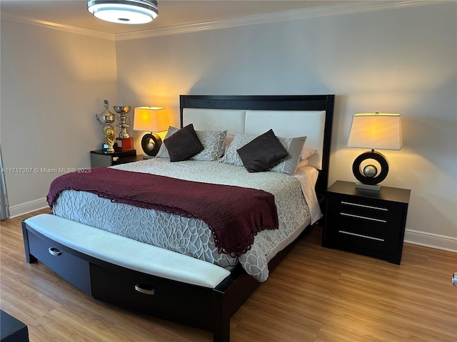 bedroom with baseboards, wood finished floors, and crown molding