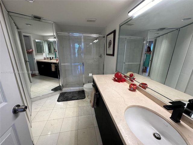 full bath with tile patterned flooring, toilet, vanity, visible vents, and a stall shower