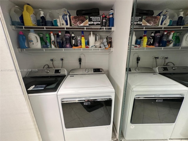 clothes washing area featuring laundry area and washing machine and clothes dryer