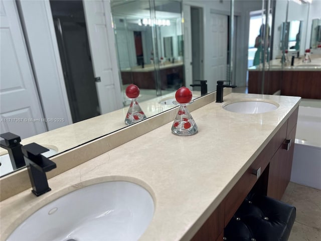 bathroom featuring double vanity, tile patterned flooring, and a sink