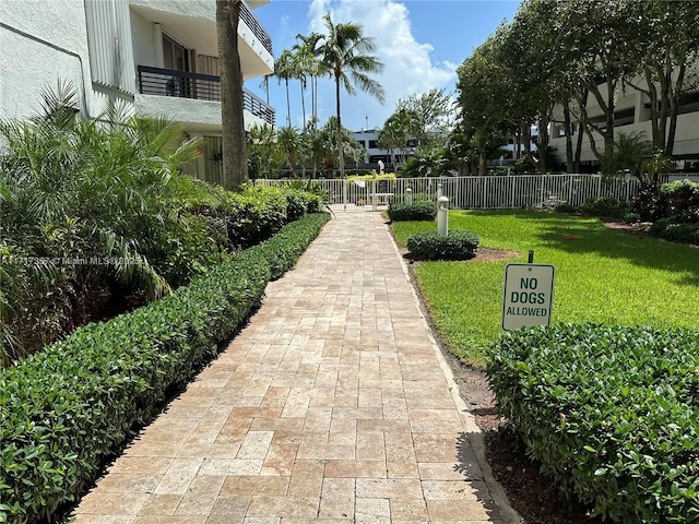 view of home's community featuring fence and a lawn