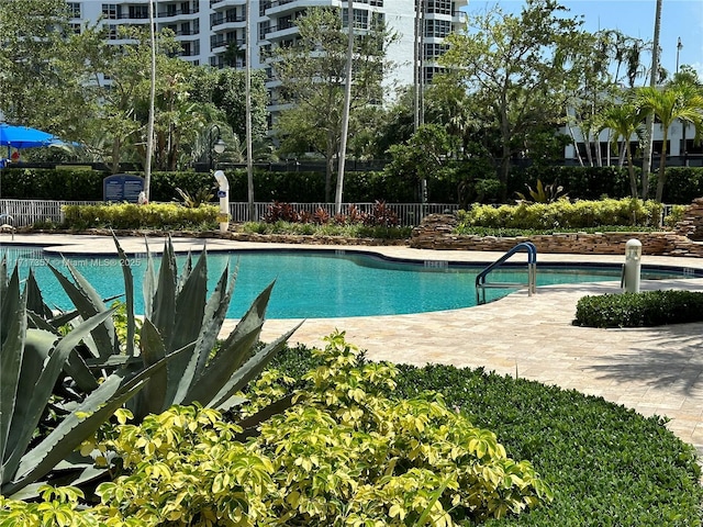 community pool featuring a patio area and fence