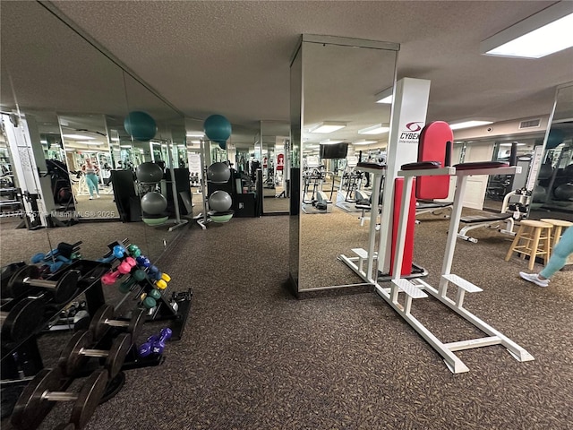 gym featuring visible vents and a textured ceiling