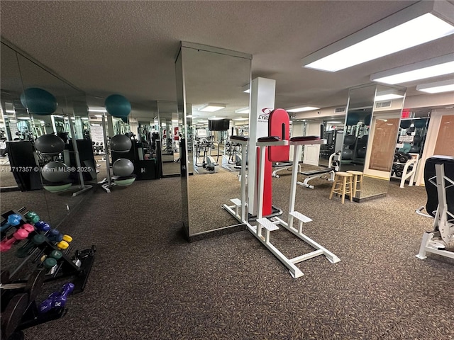 exercise room featuring a textured ceiling and visible vents