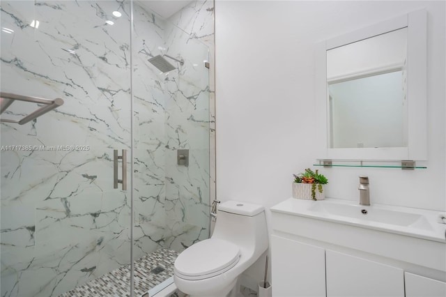 bathroom featuring an enclosed shower, vanity, and toilet