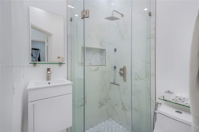 bathroom featuring walk in shower, vanity, and toilet