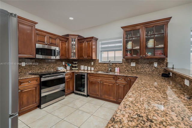 kitchen featuring sink, stainless steel appliances, wine cooler, stone countertops, and decorative backsplash