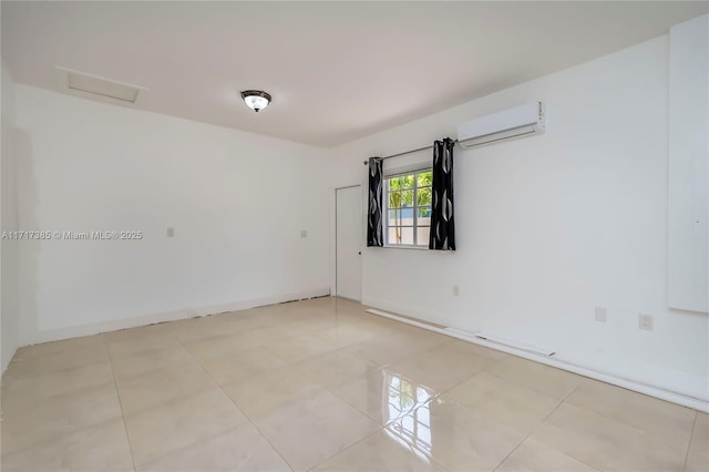 tiled empty room with a wall mounted air conditioner