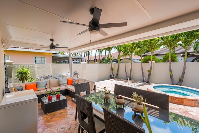 view of patio / terrace featuring an in ground hot tub and an outdoor living space