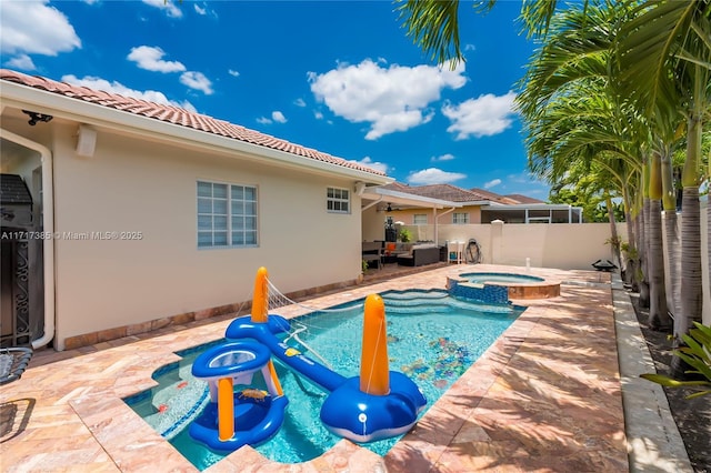 view of swimming pool featuring a patio and an in ground hot tub