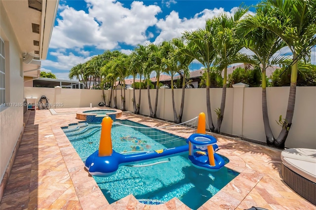 view of pool featuring a patio and an in ground hot tub