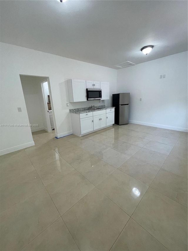 kitchen with white cabinetry and appliances with stainless steel finishes