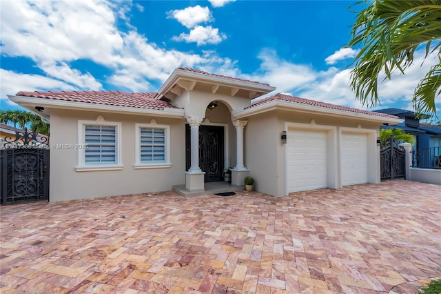 mediterranean / spanish-style home with a garage