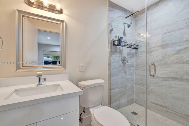 bathroom featuring vanity, toilet, and walk in shower