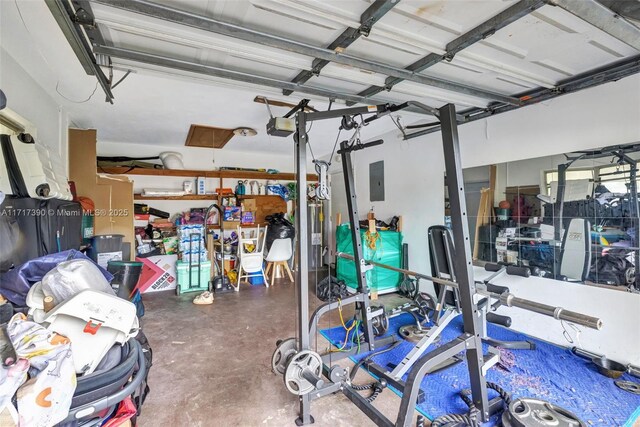 garage with electric panel and a garage door opener