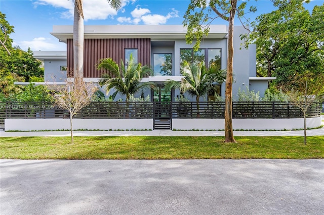 contemporary home with a front lawn