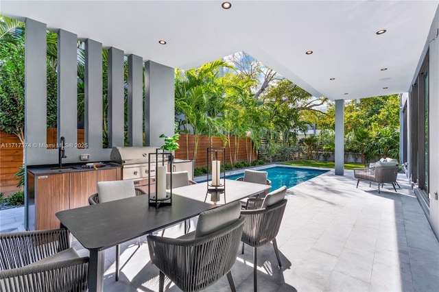 view of pool featuring a patio and sink