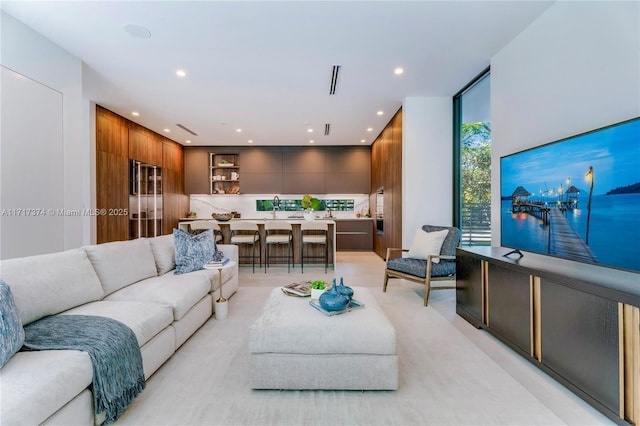 living room with wooden walls and sink