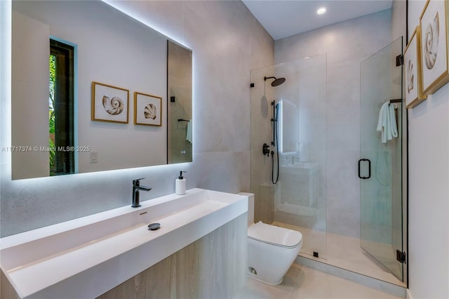 bathroom with tile patterned floors, vanity, an enclosed shower, and toilet