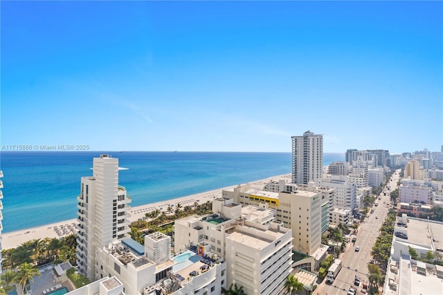 birds eye view of property with a view of the beach and a water view