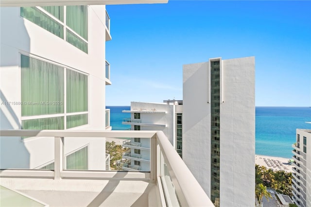 balcony featuring a water view and a view of the beach