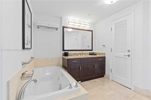 bathroom featuring tile patterned flooring, vanity, and a tub to relax in