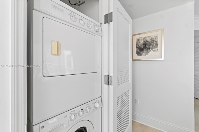 laundry area featuring stacked washing maching and dryer