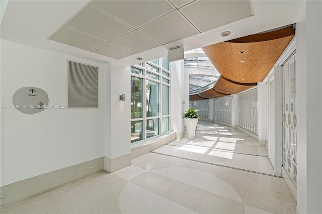 hallway with floor to ceiling windows