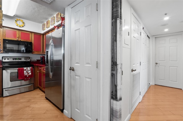 kitchen with light hardwood / wood-style flooring and stainless steel appliances