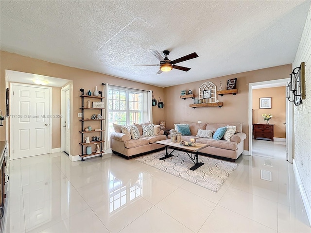 tiled living room featuring a textured ceiling and ceiling fan