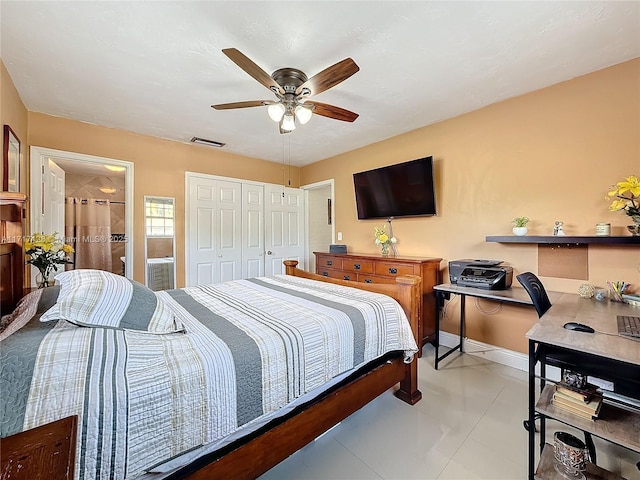 bedroom with connected bathroom, ceiling fan, a closet, and light tile patterned floors